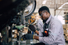 iStock-worker-standing-machine-2197703936.jpg
